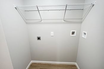 a room with white walls and a white ceiling and a wire rack on the ceiling